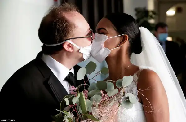 Coronavirus: Newlyweds kiss in Italy through protective masks at their wedding (Photos)