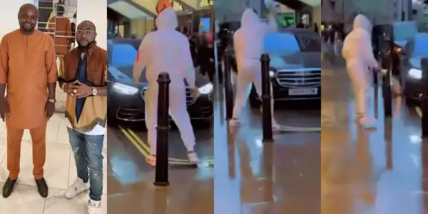 Isreal DMW stands in the rain to hail his boss, Davido (Video)