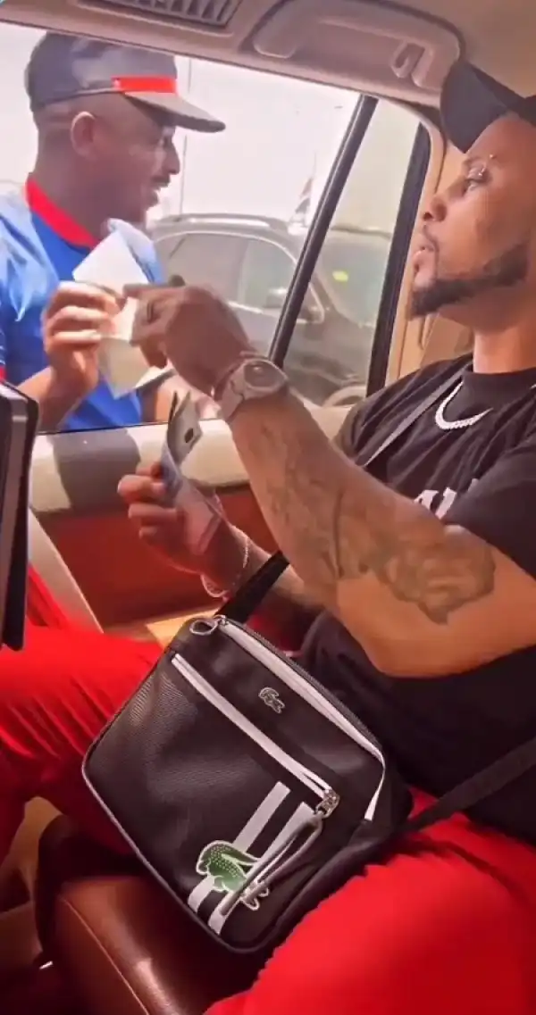 Davido’s Cousin, B-red Spotted Sharing Money On The Street (Video)