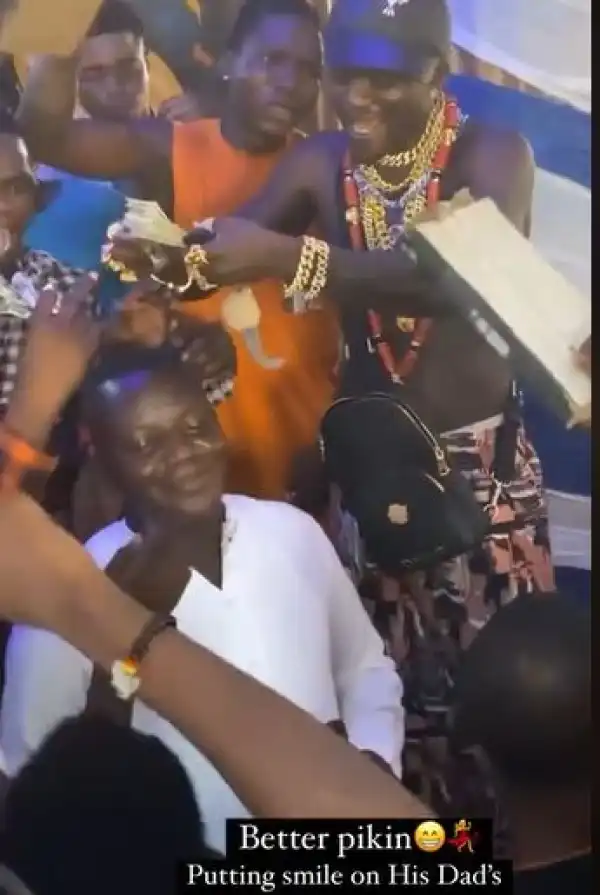 Portable Puts A Smile On His Father’s Face As He Sprays Him Dollar Notes (Video)