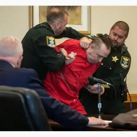 Dramatic moment convicted murderer who has 'k!ller' inscribed on his teeth, punches his defense lawyer after he is sentenced to d3ath for k!lling child and babysitter