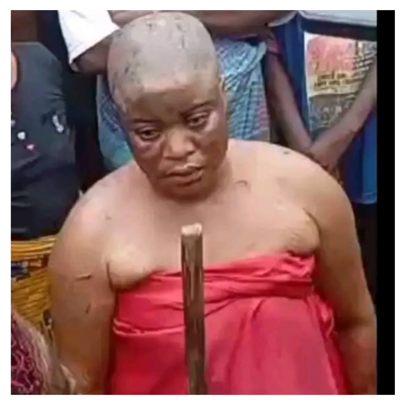 Community parades ex-monarch’s wife for allegedly burying charms