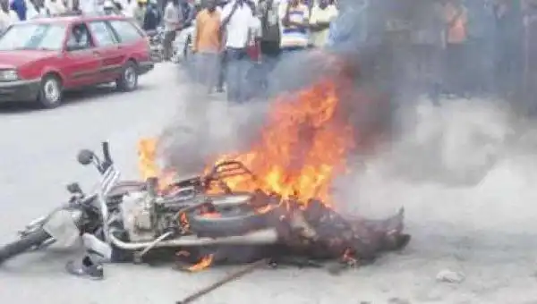 Graphic Photo: 2 Okada Snatchers Nabbed, Beaten To Death And Set Ablaze In Abuja