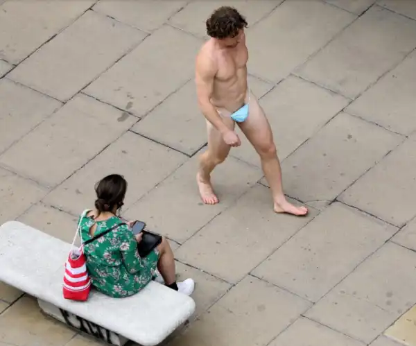 Naked man strolls down Oxford Street wearing nothing but mask